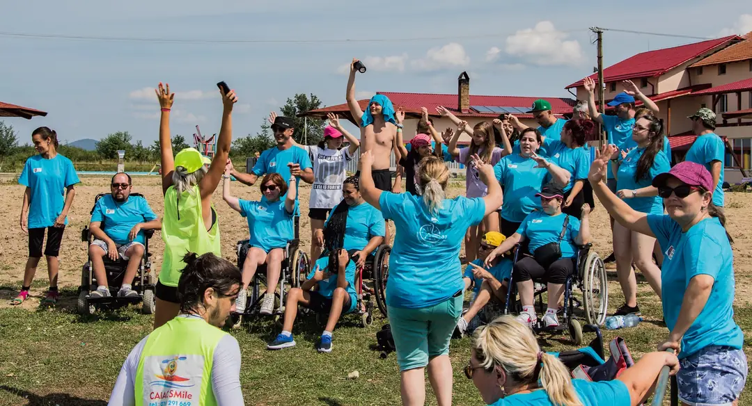 A large group with their arms raised
