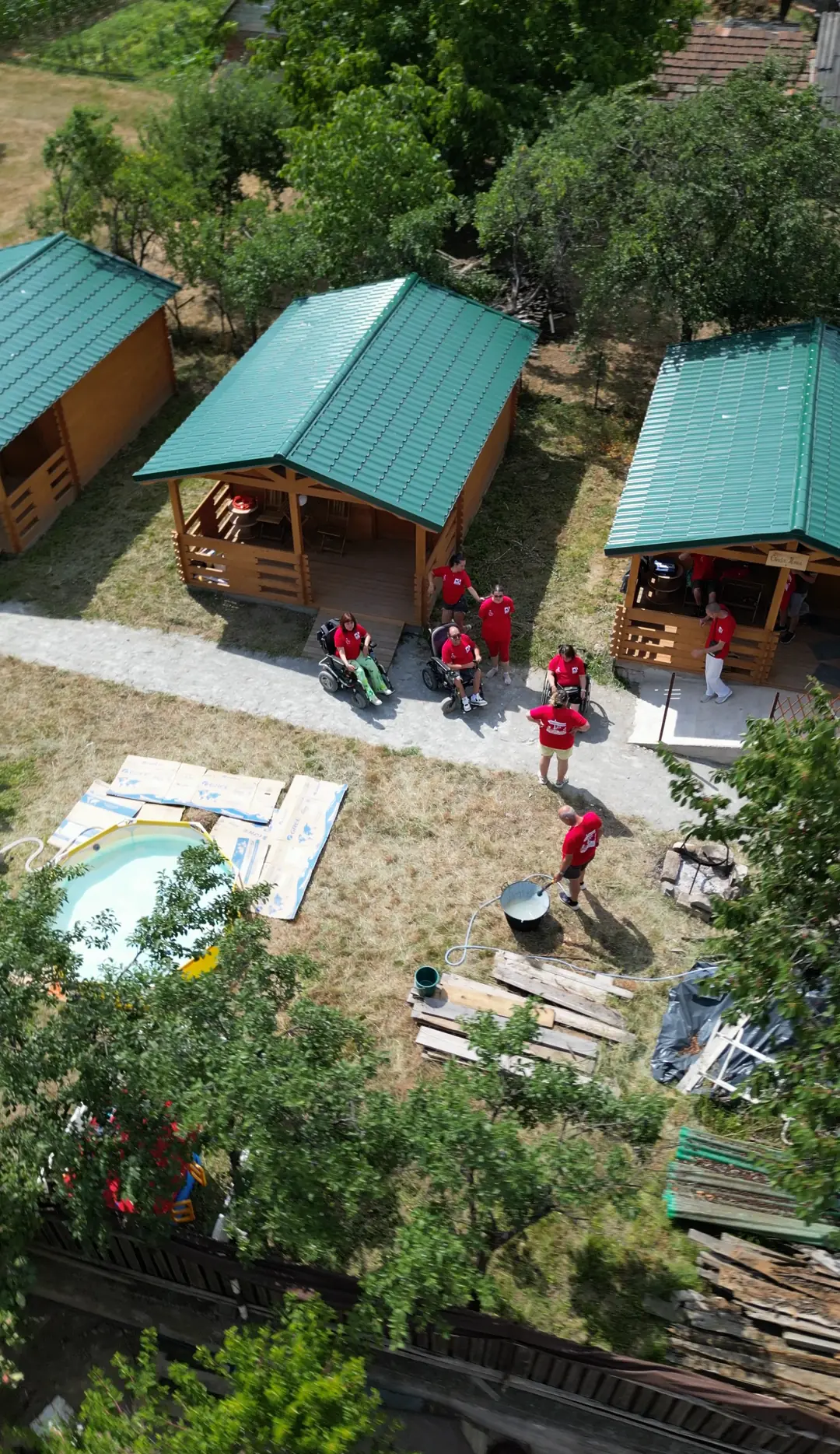The wooden cabins of the Friendship House in Pietroasa, filmed from above by drone