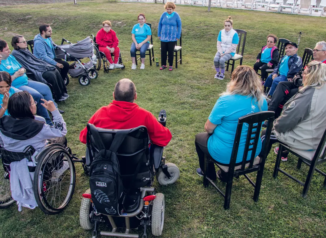 Participants sitting in a circle on the grass during a workshop